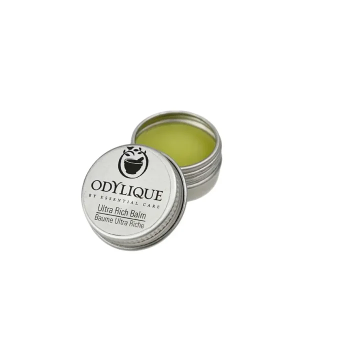 Odylique Baume Ultra Riche échantillon – boîte métal argentée ouverte, baume jaune-vert